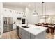 Modern kitchen boasts a spacious island, stainless steel appliances, and sleek white cabinetry at 18614 E Oriole Way, Queen Creek, AZ 85142