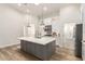 Spacious kitchen featuring a large island, modern lighting, and ample cabinet space at 18614 E Oriole Way, Queen Creek, AZ 85142