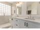 Main bathroom featuring double sinks, ample counter space, and a glass shower at 18614 E Oriole Way, Queen Creek, AZ 85142