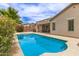 Backyard pool with desert landscaping, privacy wall, patio area and exterior view of the back of the house at 18614 E Oriole Way, Queen Creek, AZ 85142