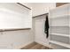 A walk-in closet with built in shelving and wood floor at 18614 E Oriole Way, Queen Creek, AZ 85142