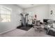 Bedroom featuring home gym with weight machine, chair, desk and natural light from two windows at 20496 W Valley View Dr, Buckeye, AZ 85396