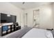 Bedroom with access to bath, large flat screen tv and cube storage at 20496 W Valley View Dr, Buckeye, AZ 85396