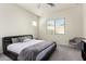 Bright bedroom with a large window, soft carpet, and ceiling fan at 20496 W Valley View Dr, Buckeye, AZ 85396