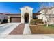 Charming single-story home featuring an arched entryway, desert landscaping, and an attached two-car garage at 20496 W Valley View Dr, Buckeye, AZ 85396