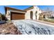 Beautiful single-story home featuring a well-kept lawn, xeriscaping, and a spacious driveway leading to a garage at 20496 W Valley View Dr, Buckeye, AZ 85396