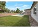 Expansive backyard featuring a lush lawn and a sparkling swimming pool, perfect for outdoor relaxation and entertainment at 20823 S 185Th Way, Queen Creek, AZ 85142
