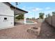 Spacious backyard with a pool, covered patio, and a stone fire pit, creating an ideal outdoor living space at 20823 S 185Th Way, Queen Creek, AZ 85142