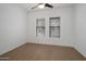 Bright bedroom with wood floors, two windows with blinds, and fresh, white paint for a clean and modern feel at 20823 S 185Th Way, Queen Creek, AZ 85142