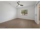 Bright bedroom with wood floors, a ceiling fan, and a bright window that provides natural light at 20823 S 185Th Way, Queen Creek, AZ 85142