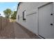 Side view of a well-maintained home with a brick walkway and a neutral color scheme, offering a clean and modern aesthetic at 20823 S 185Th Way, Queen Creek, AZ 85142