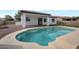 Inviting backyard pool with a tanning ledge surrounded by well-maintained landscaping and clear blue water at 20823 S 185Th Way, Queen Creek, AZ 85142