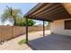 Enclosed backyard area with covered patio, stone landscaping, and privacy wall at 2164 S Estrella Cir, Mesa, AZ 85202