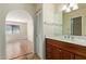 Well-lit bathroom featuring a vanity with wood cabinets, marble countertop, and modern fixtures at 2164 S Estrella Cir, Mesa, AZ 85202