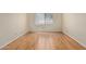 Empty bedroom featuring wood-look flooring and a bright window at 2164 S Estrella Cir, Mesa, AZ 85202