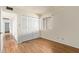 Cozy bedroom with wood-look floors, closet and bright window at 2164 S Estrella Cir, Mesa, AZ 85202