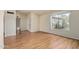 Bright living room featuring wood-look flooring and a large window at 2164 S Estrella Cir, Mesa, AZ 85202