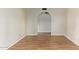 Open space that features wood-look flooring and an arched entryway at 2164 S Estrella Cir, Mesa, AZ 85202