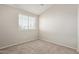 Bedroom with neutral carpet, a large window with blinds, and fresh paint at 2301 E University Dr # 172, Mesa, AZ 85213