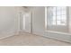 Empty bedroom featuring plush carpet and a well-lit window at 2301 E University Dr # 172, Mesa, AZ 85213