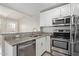 Modern kitchen featuring stainless steel appliances and breakfast bar seating at 2301 E University Dr # 172, Mesa, AZ 85213