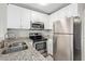 Well-lit kitchen features granite countertops and stainless steel appliances at 2301 E University Dr # 172, Mesa, AZ 85213
