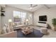 Bright living room featuring a large window, ceiling fan and comfortable furniture at 2301 E University Dr # 172, Mesa, AZ 85213