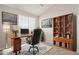 Comfortable home office featuring a wood desk, leather chair, and built-in bookcase for storage and organization at 2301 E University Dr # 172, Mesa, AZ 85213