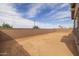 A spacious backyard is surrounded by a block wall, offering a private outdoor space at 23036 E Oriole Way, Queen Creek, AZ 85142
