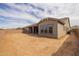 A spacious backyard features a covered patio, block fence, and ample space for landscaping and recreation at 23036 E Oriole Way, Queen Creek, AZ 85142