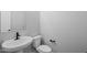 Modern half-bath features a white pedestal sink and toilet with black hardware and fixtures at 23036 E Oriole Way, Queen Creek, AZ 85142