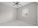 A bright, empty bedroom with neutral paint, carpet, and a window with white shutters at 23036 E Oriole Way, Queen Creek, AZ 85142