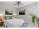 Cozy bedroom with natural light features wood accents, stylish decor and ceiling fan at 23036 E Oriole Way, Queen Creek, AZ 85142