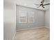 Bright empty bedroom features neutral walls, vinyl plank flooring and shutters on the windows at 23036 E Oriole Way, Queen Creek, AZ 85142