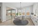 Bright dining room features modern chandelier and sliding glass doors to outdoor space at 23036 E Oriole Way, Queen Creek, AZ 85142
