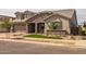 Charming two-story home with a stone facade, well-manicured lawn, and three-car garage at 23036 E Oriole Way, Queen Creek, AZ 85142