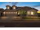 Charming single-Gathering home with a three-car garage, stone accents, and well-manicured landscaping at 23036 E Oriole Way, Queen Creek, AZ 85142