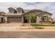 Beautiful two-story home with stone facade, three-car garage, and drought-tolerant landscaping at 23036 E Oriole Way, Queen Creek, AZ 85142