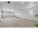 Spacious three car garage with neutral paint, bright lighting, and a window for natural light at 23036 E Oriole Way, Queen Creek, AZ 85142