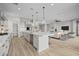 Modern kitchen with stainless steel appliances, a large island, and hardwood floors at 23036 E Oriole Way, Queen Creek, AZ 85142