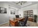 The office has a desk with a chair, shelving and artwork on the wall at 23036 E Oriole Way, Queen Creek, AZ 85142