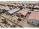 An aerial shot shows the house with gravel landscaping, turf, and a covered patio in a gated community at 23690 W Ripple Rd, Buckeye, AZ 85326