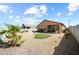 Low maintenance backyard with gravel landscape, a small patch of artificial turf, and desert plants at 23690 W Ripple Rd, Buckeye, AZ 85326