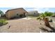 Spacious gravel backyard featuring a small square of artificial turf and desert landscaping at 23690 W Ripple Rd, Buckeye, AZ 85326