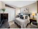 Inviting bedroom featuring a queen bed with plush pillows, complemented by a large artwork on the wall at 23690 W Ripple Rd, Buckeye, AZ 85326
