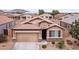 Charming single-Gathering home featuring a two-car garage, desert landscaping, and a tile roof in a residential neighborhood at 23690 W Ripple Rd, Buckeye, AZ 85326