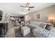 Inviting living room adjacent to modern kitchen, furnished with plush seating and contemporary decor at 23690 W Ripple Rd, Buckeye, AZ 85326