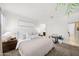 Serene main bedroom featuring soft lighting, neutral colors, and plush bedding for ultimate relaxation at 23690 W Ripple Rd, Buckeye, AZ 85326