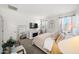 Comfortable main bedroom showcasing a decorative fireplace, large mirror and an abundance of natural light at 23690 W Ripple Rd, Buckeye, AZ 85326