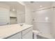 Modern bathroom with sleek vanity, large mirror, and walk-in shower featuring white subway tile at 25109 N 174Th Ln, Surprise, AZ 85387
